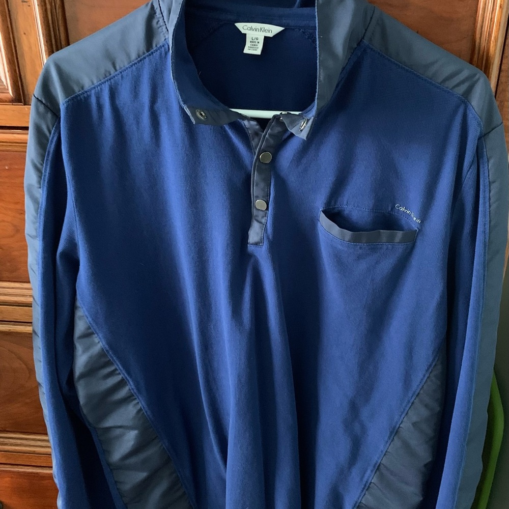 Calvin Klein men's pullover in blue with snaps at top.
